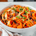 Carrot ribbon salad with sesame and lime in bowl