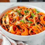 Carrot ribbon salad with sesame and lime in bowl