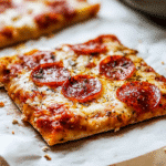 Chicken crust pizza sliced with melted cheese and pepperoni