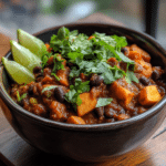 Sweet Potato & Black Bean Chili served with avocado and lime
