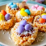 Colorful Easter Rice Krispie Nests filled with candy eggs in a muffin tin