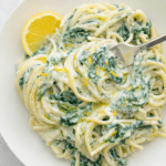 Creamy lemon ricotta pasta with spinach and parmesan in a bowl