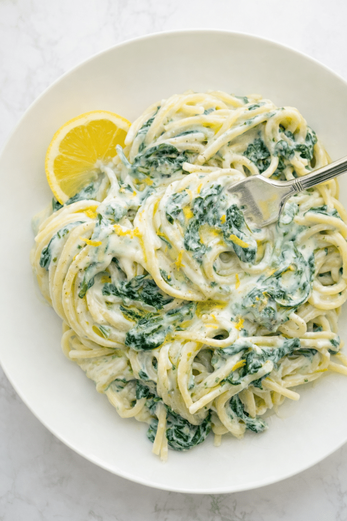 Creamy lemon ricotta pasta with spinach and parmesan in a bowl