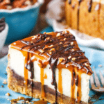 Turtle cheesecake topped with caramel, chocolate ganache, and pecans