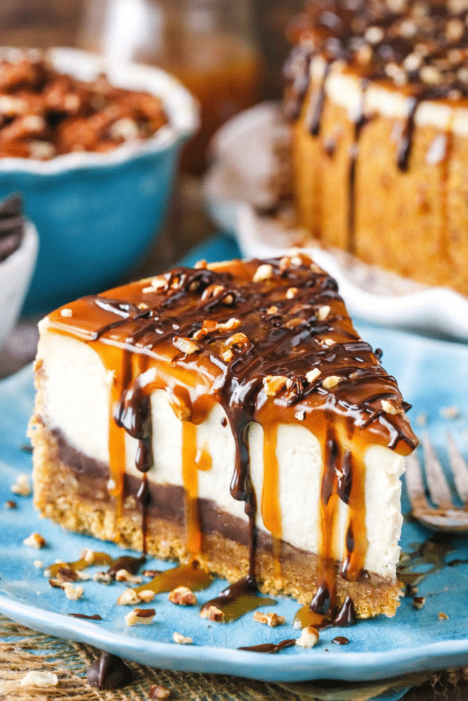 Turtle cheesecake topped with caramel, chocolate ganache, and pecans