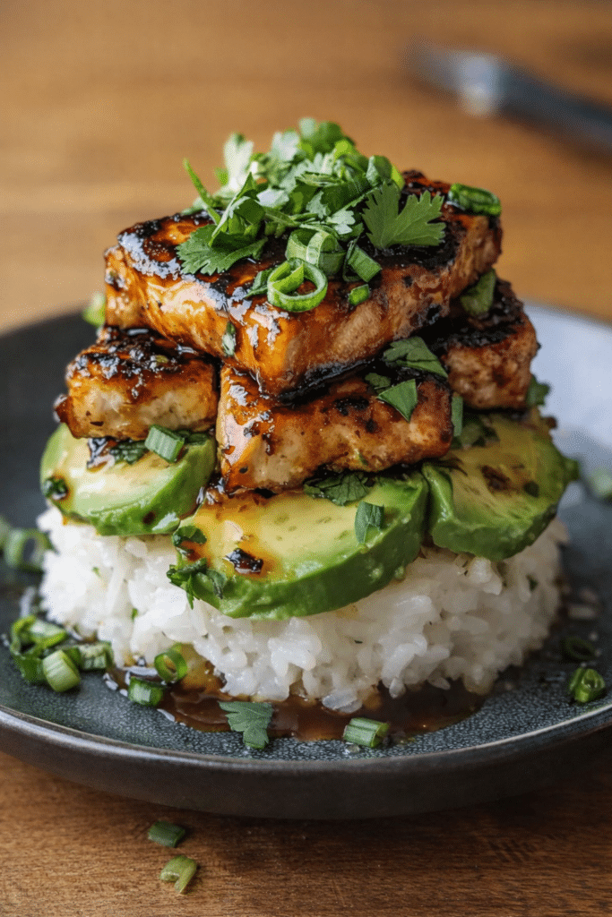 Fresh Honey Lime Chicken served over creamy avocado rice with cilantro and lime wedges.