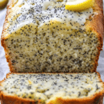 Homemade lemon poppy seed bread with bright lemon glaze and soft crumb texture.