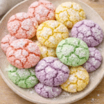 Springtime crinkle cookies coated in powdered sugar with pastel colors