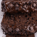 Slice of moist chocolate banana bread served with fresh bananas