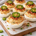 Creamy jalapeno popper deviled eggs served on a white platter