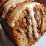 Cinnamon Roll Banana Bread sliced with cinnamon swirl and sweet glaze on top