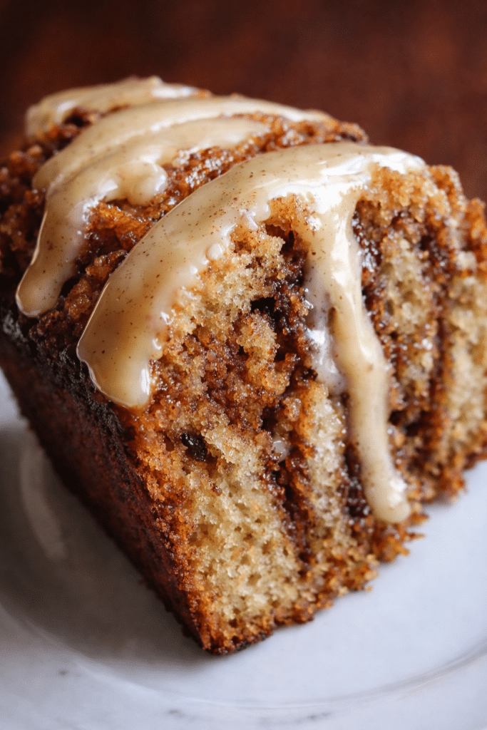 Cinnamon Roll Banana Bread sliced with cinnamon swirl and sweet glaze on top