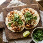 Smash dumpling tacos with crispy pork filling and sriracha mayo on a wooden board